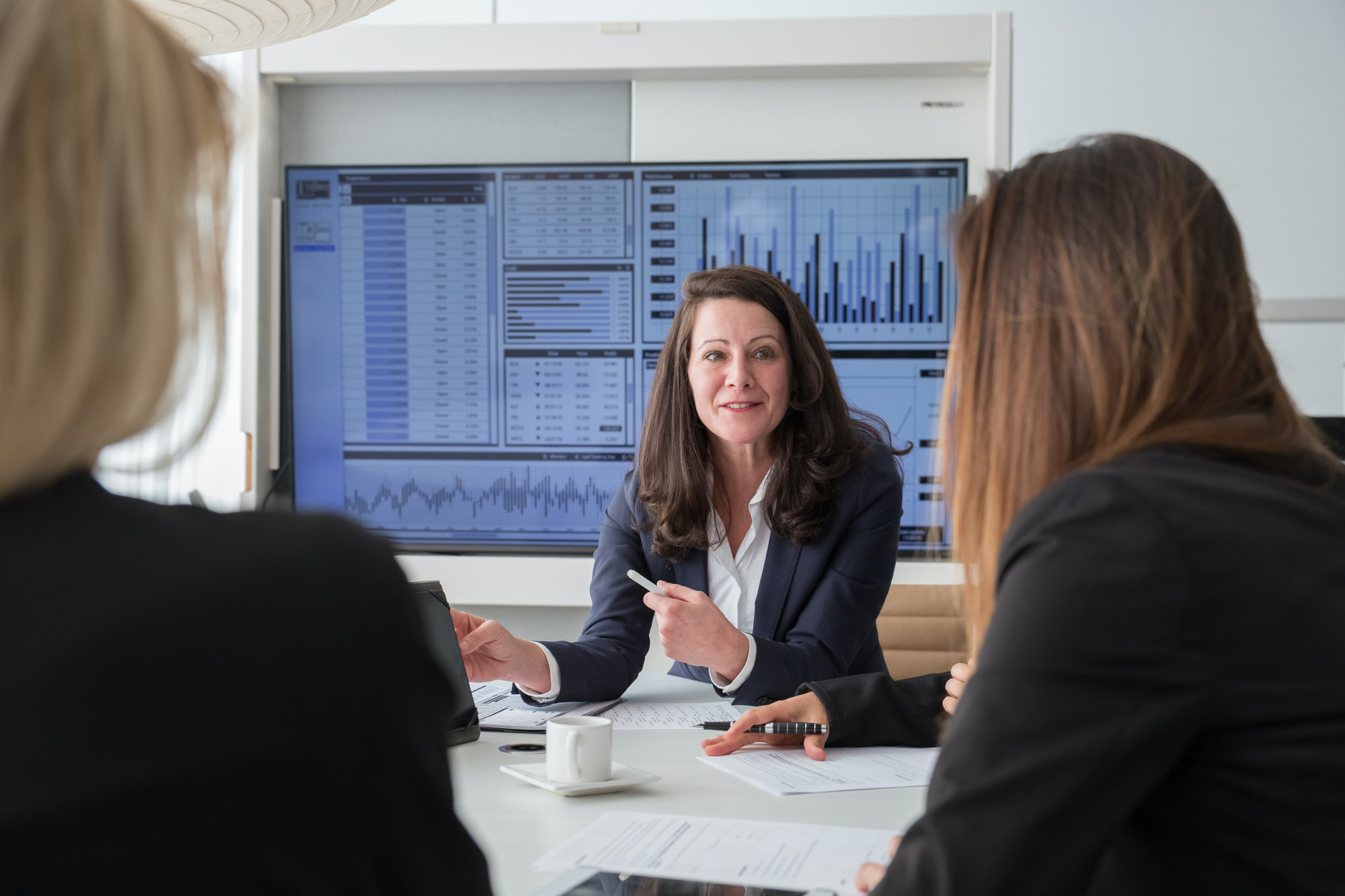 Team of professionals conducting a strategic business meeting to discuss innovative ideas and plans for success. Collaborative group discussion in a modern office setting. Productive teamwork and brainstorming session for corporate growth and development.